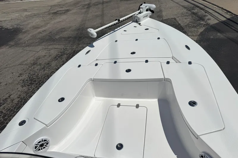 Slide: The Image of 2026 Blazer 675 Ultimate Bay boat deck with storage compartments and trolling motor. - 16