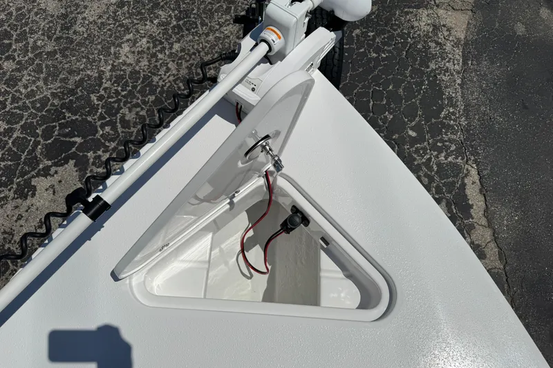 Slide: The Image of 2026 Blazer 675 Ultimate Bay boat hatch with wiring, on textured pavement background. - 24