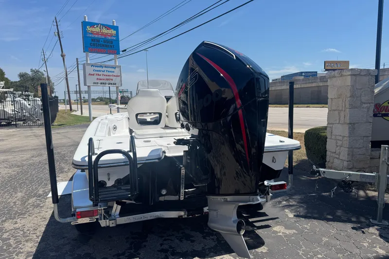 Slide: The Image of 2026 Blazer 675 Ultimate Bay boat with powerful outboard motor, parked outdoors. - 3