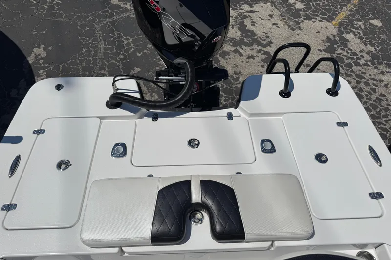 Slide: The Image of 2026 Blazer 675 Ultimate Bay boat deck with motor, featuring storage compartments and seating. - 33