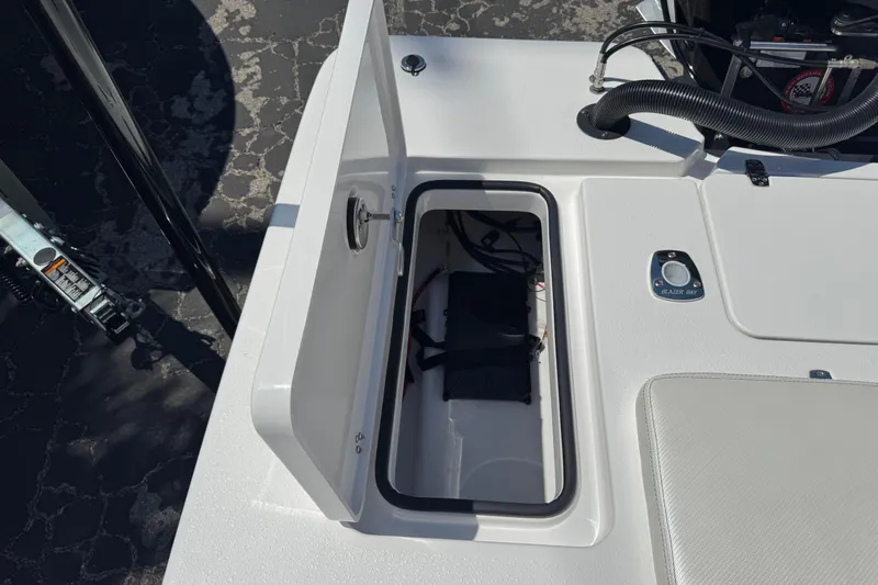 Slide: The Image of 2026 Blazer 675 Ultimate Bay boat storage compartment with open hatch and visible wiring. - 35