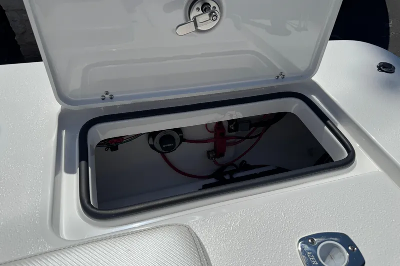 Slide: The Image of Open storage compartment in 2026 Blazer 675 Ultimate Bay boat, showing wiring and components. - 39