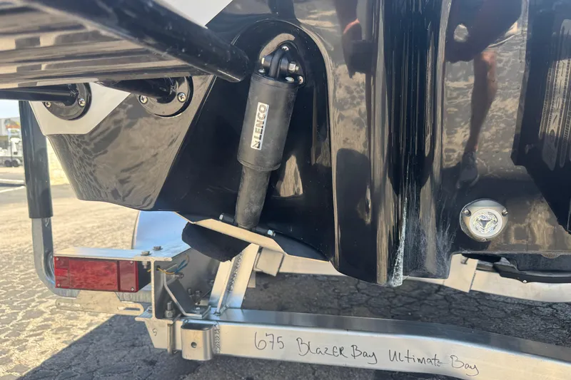Slide: The Image of 2026 Blazer 675 Ultimate Bay boat trailer detail with hydraulic components. - 7