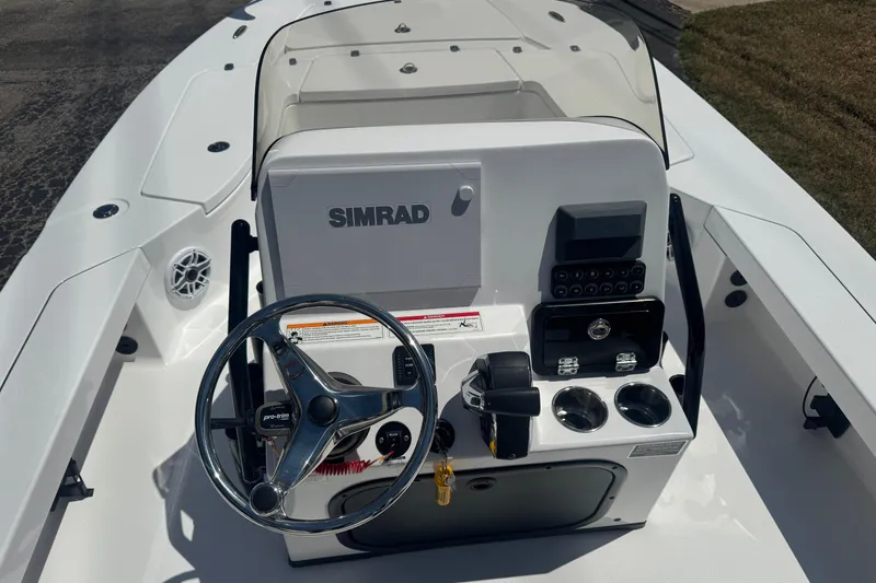 Slide: The Image of 2026 Blazer 675 Ultimate Bay boat console with steering wheel and Simrad electronics. - 9