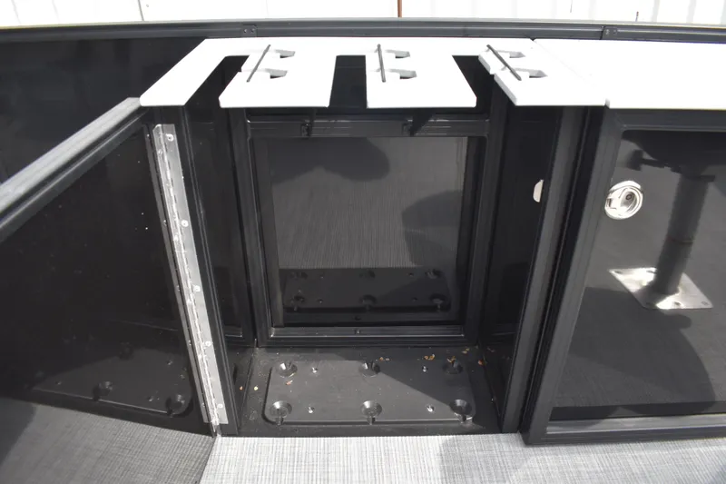 Slide: The Image of 2026 Lowe LF 214 boat interior storage compartment with sleek black and white design. - 14