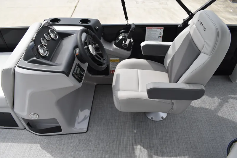 Slide: The Image of 2026 Lowe LF 214 boat interior with steering console and cushioned captain's chair. - 20