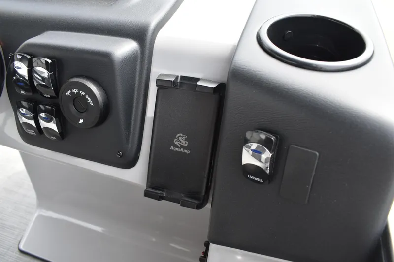 Slide: The Image of Control panel of 2026 Lowe LF 214 boat with switches and cup holder. - 24