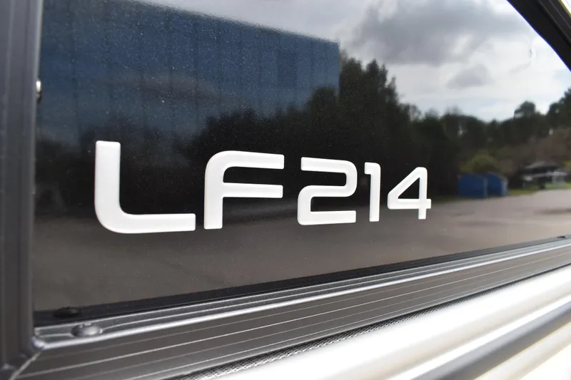 Slide: The Image of 2026 Lowe LF 214 logo on a sleek black surface, outdoors. - 33