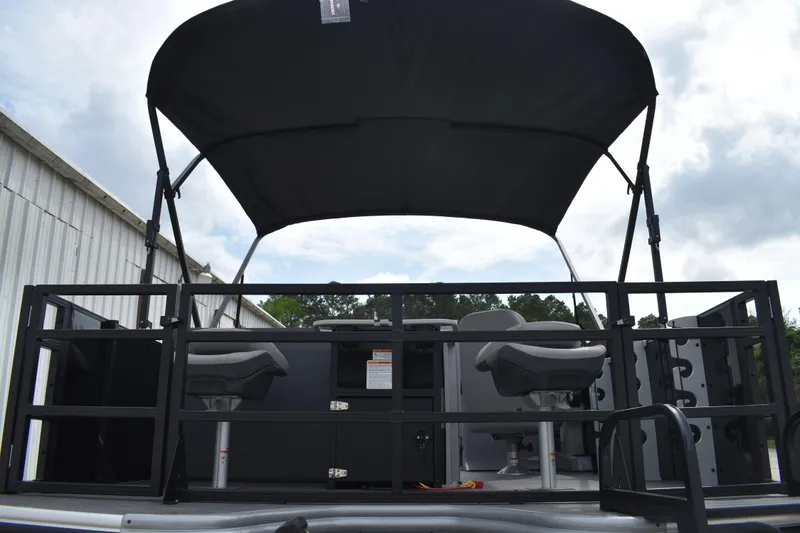 Slide: The Image of 2026 Lowe LF 214 pontoon boat with canopy and seating, docked outdoors. - 4