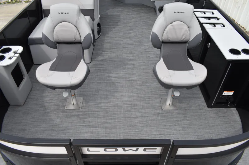Slide: The Image of 2026 Lowe LF 214 boat interior with two gray captain chairs and modern amenities. - 9