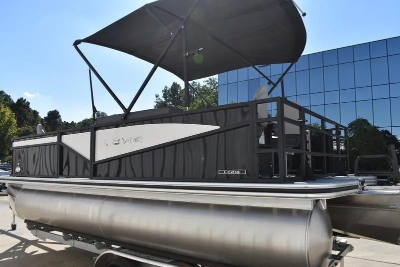 Slide: The Image of 2026 Lowe LF 214 pontoon boat on trailer, sleek black design, outdoor setting. - 10