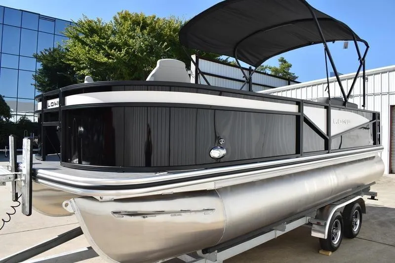 Slide: The Image of 2026 Lowe LF 214 boat interior with two gray swivel seats and carpeted flooring. - 13