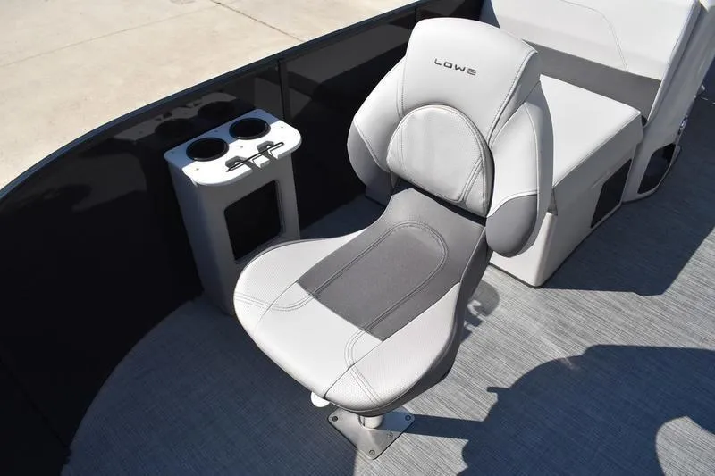 Slide: The Image of Interior view of 2026 Lowe LF 214 boat compartment with black finish and storage features. - 19