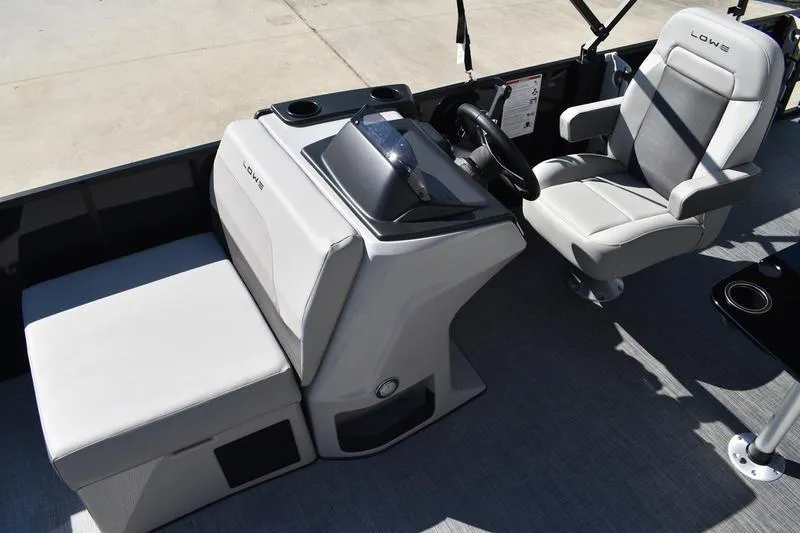Slide: The Image of 2026 Lowe LF 214 boat interior detail with speaker and storage compartment. - 29