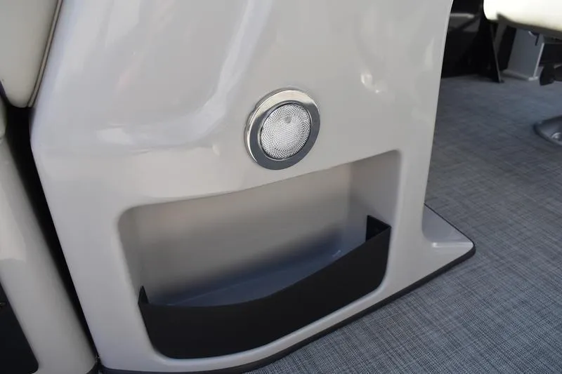 Slide: The Image of Interior view of 2026 Lowe LF 214 boat, featuring storage compartment and capacity label. - 32