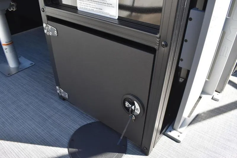 Slide: The Image of 2026 Lowe LF 214 boat storage compartment with lock and key on deck. - 48