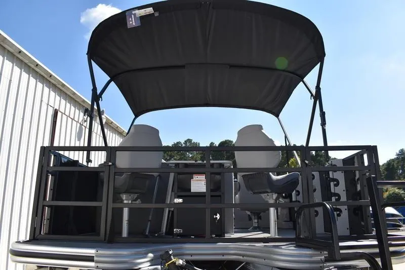 Slide: The Image of 2026 Lowe LF 214 pontoon boat with canopy and seating, docked outdoors. - 8