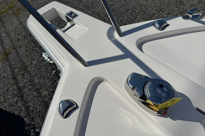 Slide: The Image of 2026 NorthCoast 235 HT boat deck with chrome fittings and anchor winch. - 13