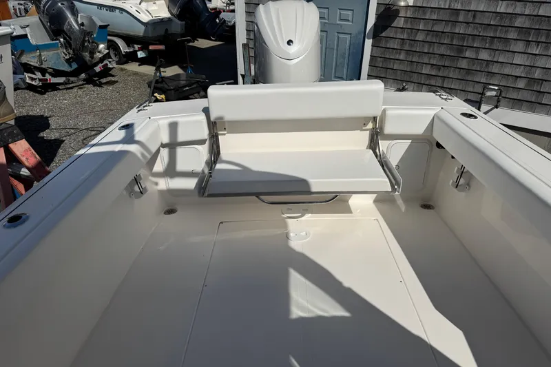 Slide: The Image of 2026 NorthCoast 235 HT boat interior with seating and outboard motor. - 14