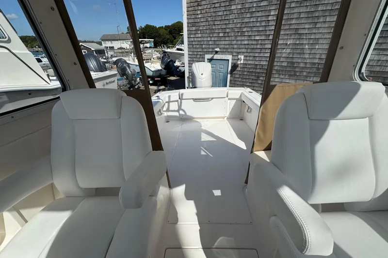 Slide: The Image of Interior view of 2026 NorthCoast 235 HT boat with white seating and spacious deck. - 23