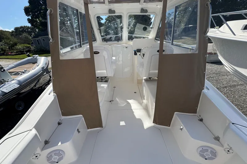 Slide: The Image of 2026 NorthCoast 235 HT boat interior with seating and windows, showcasing modern design. - 24