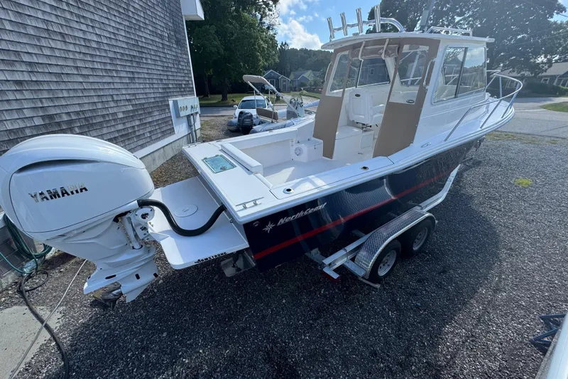 Slide: The Image of 2026 NorthCoast 235 HT boat with Yamaha engine on trailer, parked outdoors. - 26