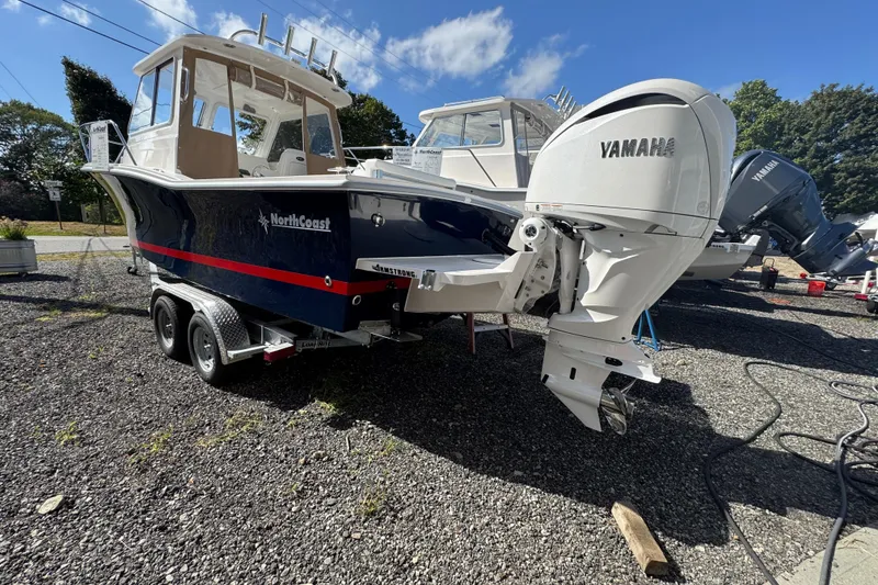 Slide: The Image of 2026 NorthCoast 235 HT boat with Yamaha engine on trailer, outdoor display. - 30