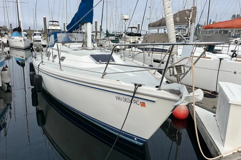 The Image of 1993 Catalina 36 sailboat docked in a marina, surrounded by other boats. - 0