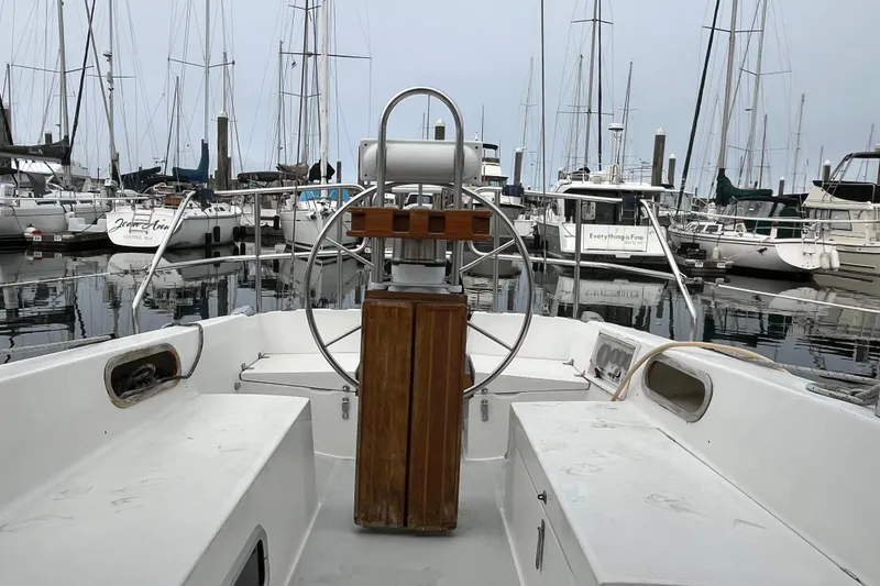 Slide: The Image of Cockpit view of a 1993 Catalina 36 sailboat docked in a marina. - 12