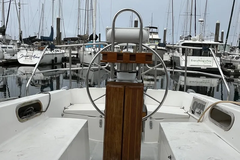 Slide: The Image of Cockpit view of a 1993 Catalina 36 sailboat docked in a marina. - 13