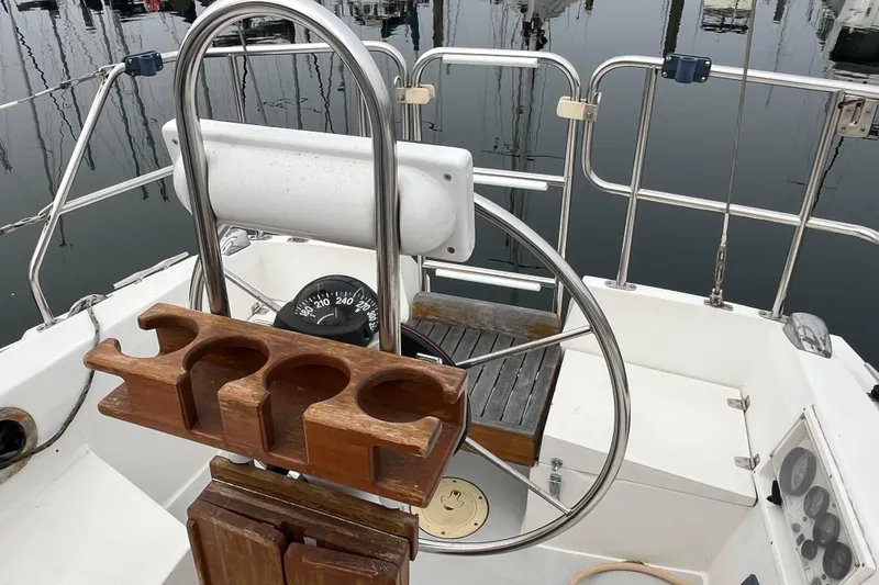 Slide: The Image of Cockpit of 1993 Catalina 36 sailboat with steering wheel and wooden cup holder. - 14