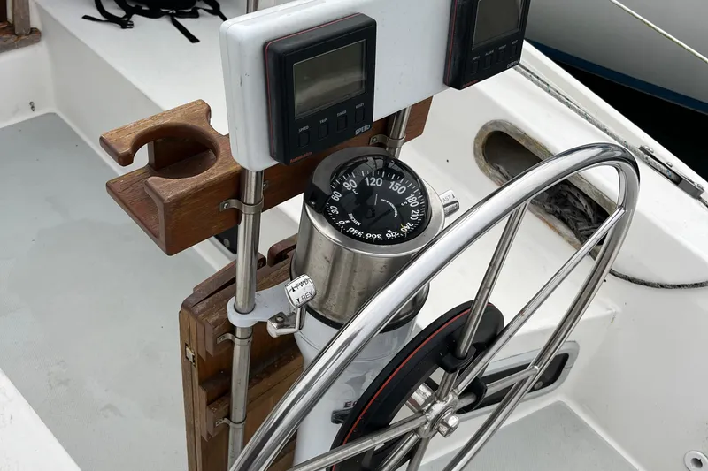 Slide: The Image of Steering wheel and compass on a 1993 Catalina 36 sailboat cockpit. - 15