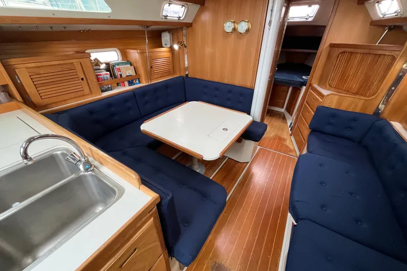 Slide: The Image of Interior of 1993 Catalina 36 sailboat with blue seating and wooden finishes. - 20