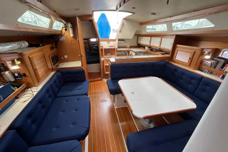Slide: The Image of Interior of a 1993 Catalina 36 sailboat with blue seating and wooden accents. - 21