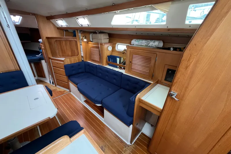 Slide: The Image of Interior of a 1993 Catalina 36 sailboat with wooden furnishings and blue upholstery. - 22