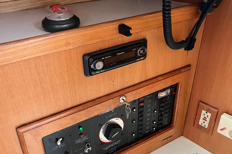 Slide: The Image of Control panel of a 1993 Catalina 36 sailboat with radio and electrical switches. - 24