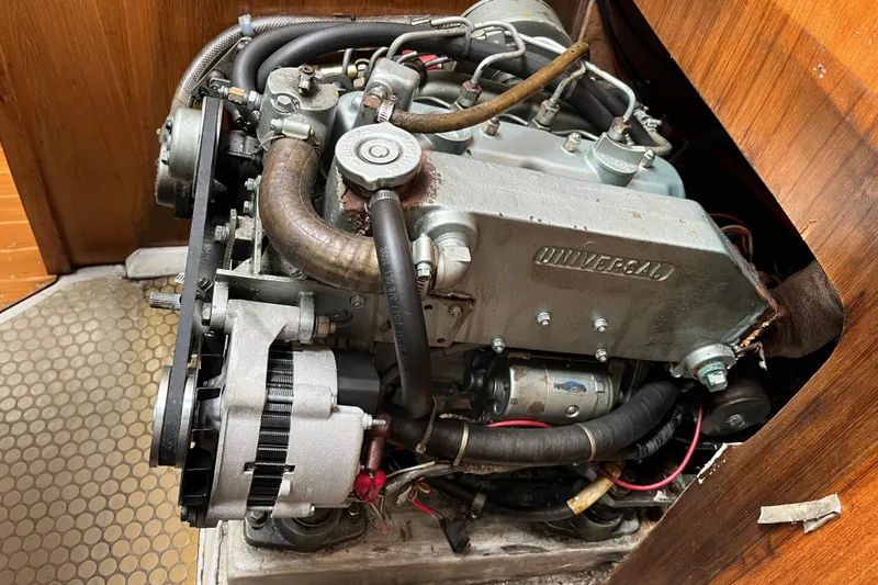Slide: The Image of Engine of a 1993 Catalina 36 sailboat, featuring a Universal diesel engine. - 30