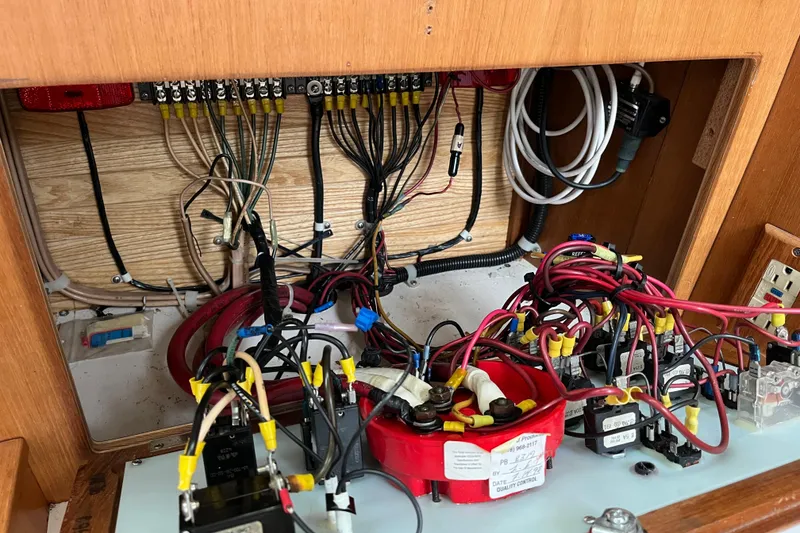 Slide: The Image of Electrical wiring panel inside a 1993 Catalina 36 sailboat, showcasing complex cable connections. - 31