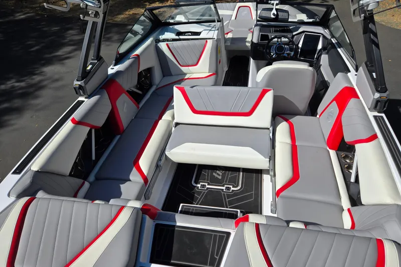 Slide: The Image of 2021 Tigé 22RZX boat interior with red and gray seating, modern design. - 4