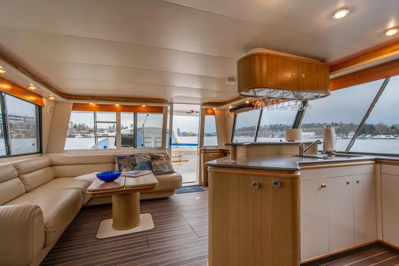 Slide: The Image of Luxurious interior of 2000 Bayliner 4788 Pilot House Motoryacht with spacious seating and modern kitchen. - 10