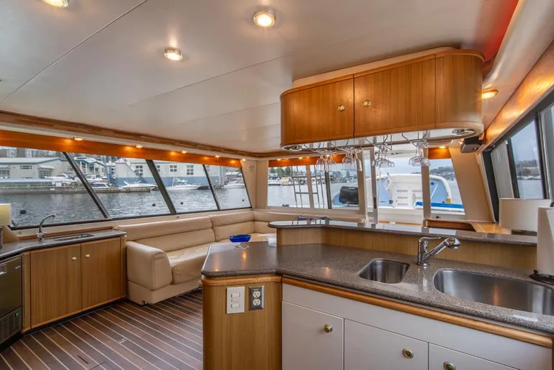 Slide: The Image of Luxurious interior of 2000 Bayliner 4788 Pilot House Motoryacht with modern kitchen and seating area. - 11