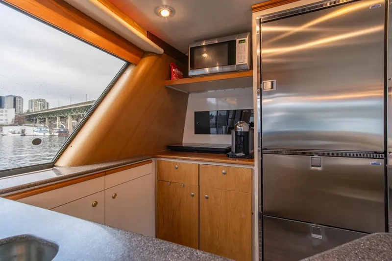 Slide: The Image of Interior of 2000 Bayliner 4788 Pilot House Motoryacht kitchen with modern appliances. - 18