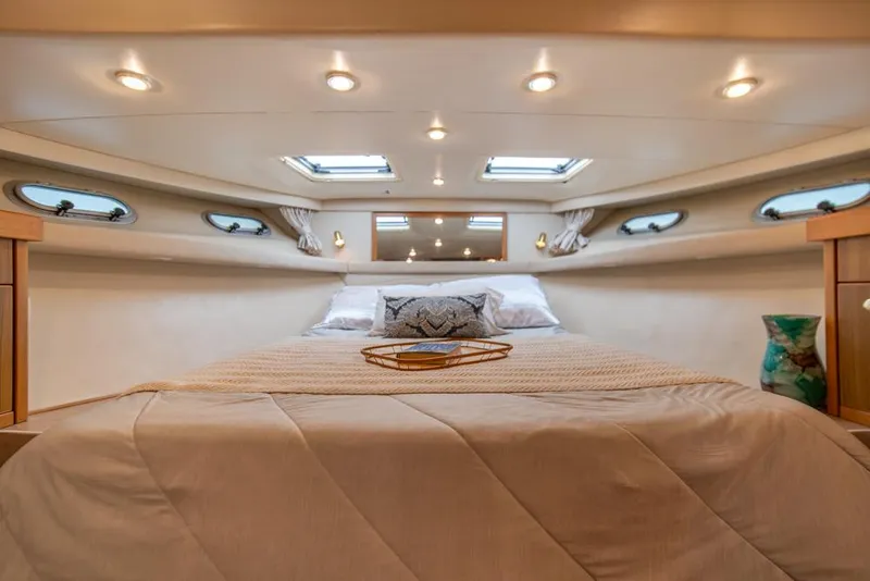 Slide: The Image of Luxurious bedroom interior of 2000 Bayliner 4788 Pilot House Motoryacht with skylights and cozy bedding. - 21