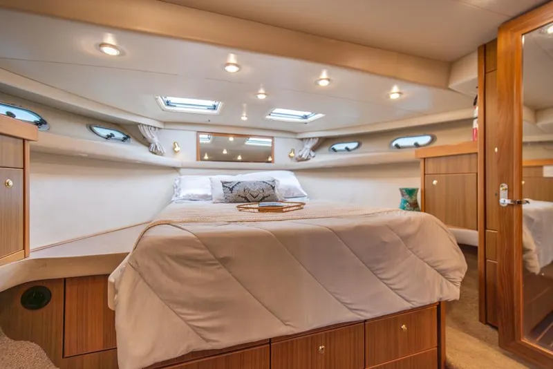 Slide: The Image of Luxurious bedroom interior of 2000 Bayliner 4788 Pilot House Motoryacht with cozy bedding. - 22