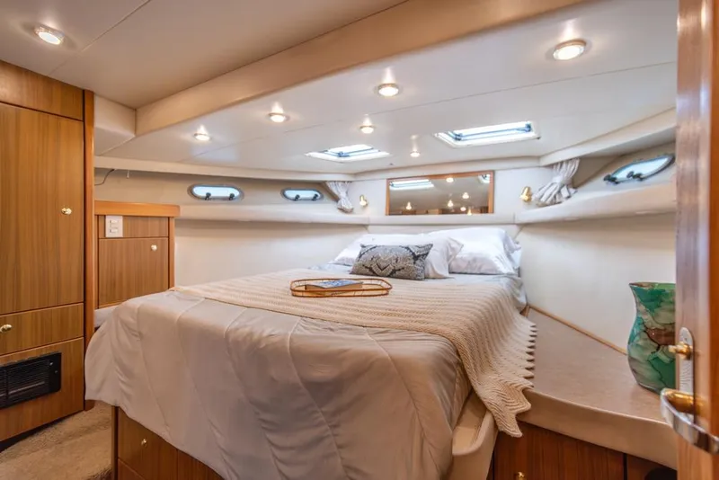 Slide: The Image of Luxurious bedroom in 2000 Bayliner 4788 Pilot House Motoryacht with cozy bedding and elegant decor. - 23