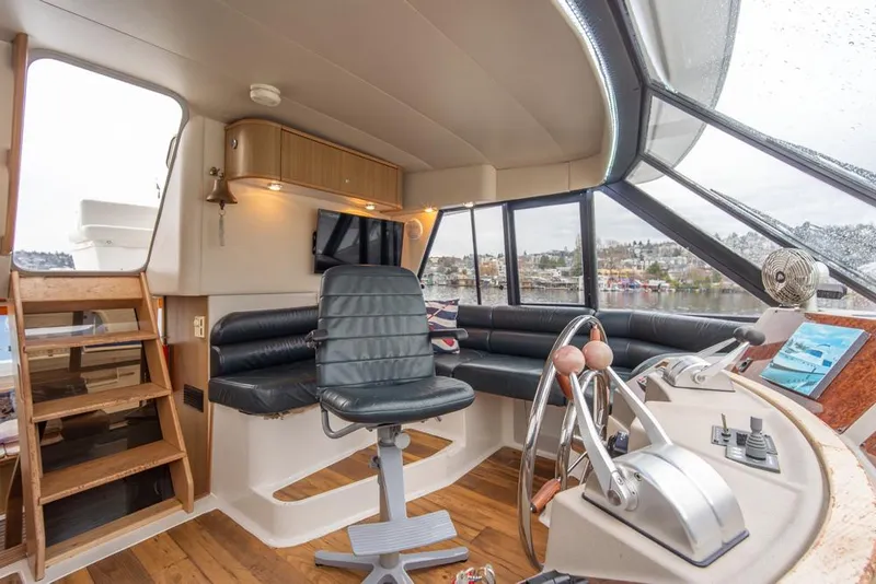 Slide: The Image of Interior of 2000 Bayliner 4788 Pilot House Motoryacht with helm and seating area. - 36