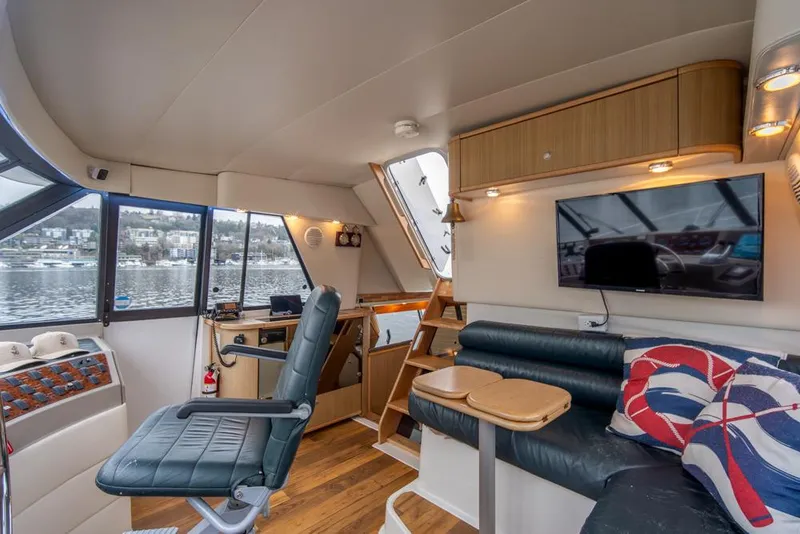 Slide: The Image of Interior of 2000 Bayliner 4788 Pilot House Motoryacht with seating, helm, and TV. - 40