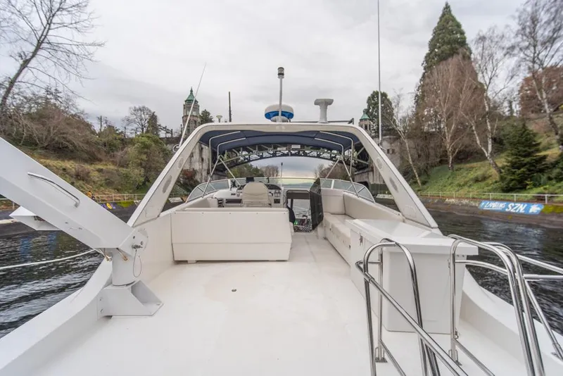 Slide: The Image of 2000 Bayliner 4788 Pilot House Motoryacht on a scenic waterway. - 46