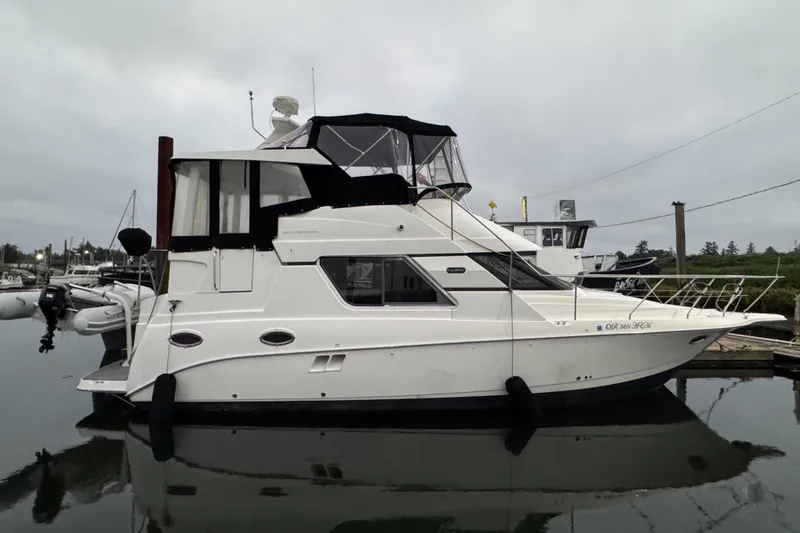 The Image of 2002 Silverton 352 Motor Yacht docked in a marina, side view. - 0