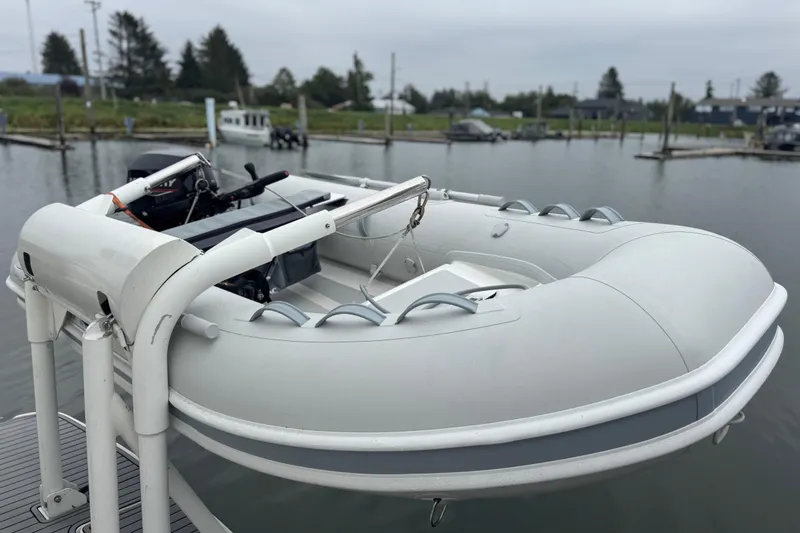 Slide: The Image of Inflatable boat on Silverton 352 Motor Yacht, 2002 model, docked in a marina. - 10